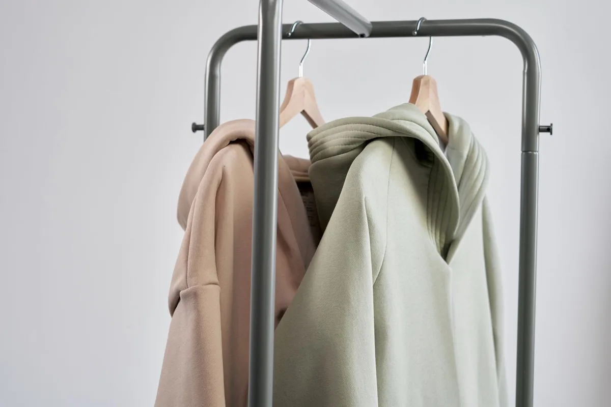 Representative stock photograph of hoodies on a rack