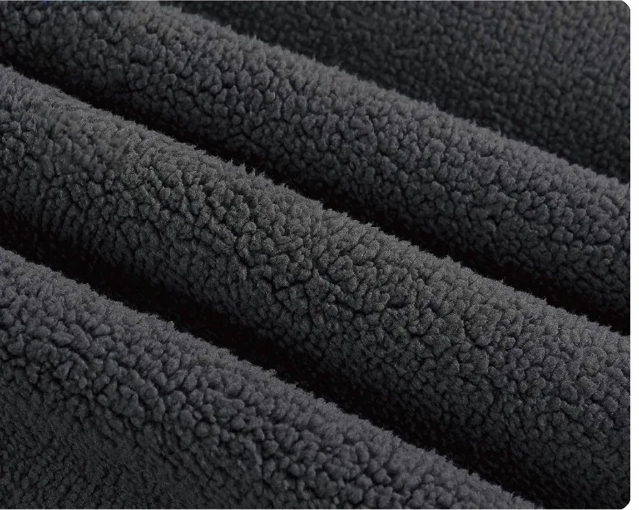 Supplier detail photograph of a dark fabric with a raised, fuzzy surface