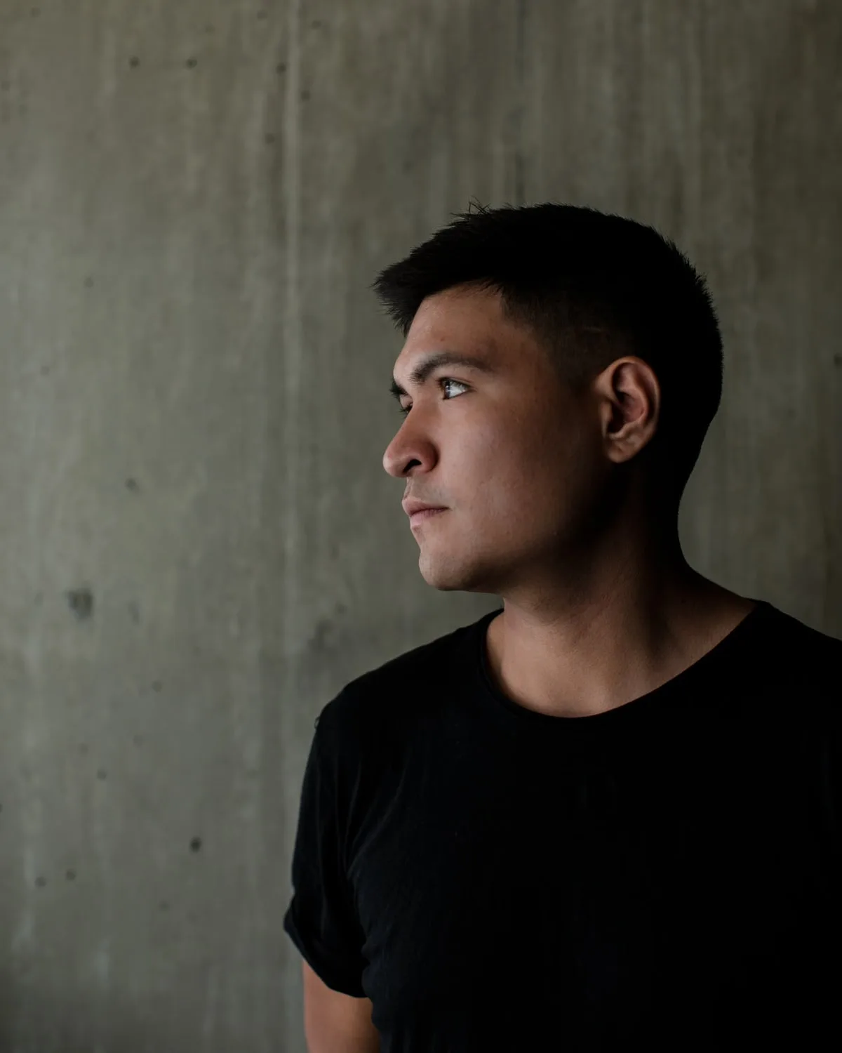 Representative lifestyle image — Styled reference — black tee, concrete light