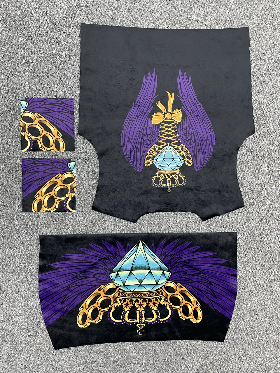 Purple, gold and turquoise graphic print on black garment panels