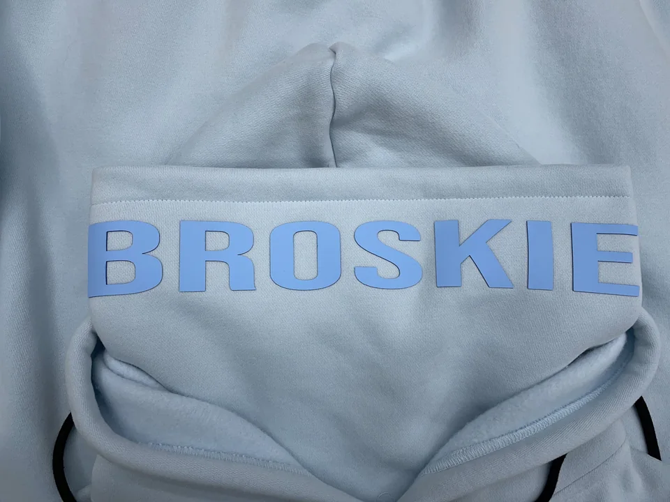 Dimensional blue lettering on a light blue garment sample